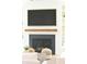 Close-up of a fireplace featuring a black hearth and wooden mantel, flanked by built-in shelves at 4176 Victory Pointe Dr, Mount Pleasant, SC 29466