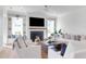 A cozy living room boasts a fireplace, built-in shelving, and comfortable white armchairs at 4176 Victory Pointe Dr, Mount Pleasant, SC 29466
