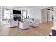 Spacious living room with white shiplap and wood floors, with fireplace and access to kitchen at 4176 Victory Pointe Dr, Mount Pleasant, SC 29466