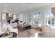 Bright and spacious living room with hardwood floors, comfortable seating, and sliding glass doors to balcony at 4176 Victory Pointe Dr, Mount Pleasant, SC 29466