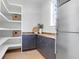 Walk-in pantry boasts ample shelving and countertop space, paired with a modern stainless steel refrigerator at 4176 Victory Pointe Dr, Mount Pleasant, SC 29466