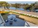An aerial view showcases a patio with a fire pit, surrounded by inviting lounge chairs and scenic landscaping at 4176 Victory Pointe Dr, Mount Pleasant, SC 29466