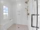 Bright shower with a built-in bench, rainfall shower head, and a handheld sprayer at 4176 Victory Pointe Dr, Mount Pleasant, SC 29466