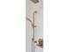 Close-up of a gold shower head and faucet with white tile in a luxurious bathroom at 4176 Victory Pointe Dr, Mount Pleasant, SC 29466