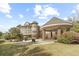 Stunning backyard with covered patio, outdoor fire pit, and meticulously manicured landscaping creating a luxurious outdoor space at 4202 Links Ct, North Charleston, SC 29420