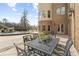 A patio with a dining table overlooks the beautiful backyard, pool and waterfall at 4202 Links Ct, North Charleston, SC 29420
