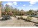 Spacious backyard with a stone-paved patio, outdoor kitchen, stone waterfall, and swimming pool at 4202 Links Ct, North Charleston, SC 29420