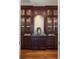 A cozy bar area with dark wood cabinets, granite countertops, and glass display cases at 4202 Links Ct, North Charleston, SC 29420