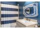Bathroom featuring a blue and white striped shower curtain, and vanity with a granite top at 4202 Links Ct, North Charleston, SC 29420