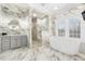 Elegant bathroom featuring marble walls, glass shower, soaking tub, and modern vanity at 4202 Links Ct, North Charleston, SC 29420