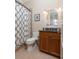Cozy bathroom featuring a standard shower and vanity with wood cabinets, offering a simple yet clean design at 4202 Links Ct, North Charleston, SC 29420