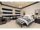 Modern bedroom with black and white decor, striped curtains, chandelier, and a cozy sitting area at 4202 Links Ct, North Charleston, SC 29420