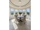 Bright dining area features tile flooring, round table, chandelier, and beautiful views from the large windows at 4202 Links Ct, North Charleston, SC 29420