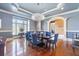 Elegant dining room with blue walls, modern chandelier, and dark wood table at 4202 Links Ct, North Charleston, SC 29420