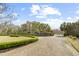 Stately brick home with manicured landscaping, a circular driveway, and gated entrance exudes curb appeal and privacy at 4202 Links Ct, North Charleston, SC 29420