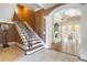 Staircase with decorative iron railing, hardwood floors, and access to the living room at 4202 Links Ct, North Charleston, SC 29420