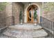 Elegant brick home entrance with curved double doors, black iron railing, and spiral topiaries at 4202 Links Ct, North Charleston, SC 29420