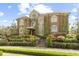 Grand two-story home featuring a brick facade, manicured landscaping, and a welcoming entrance with a stairway and brick walkway at 4202 Links Ct, North Charleston, SC 29420