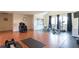 This home gym is equipped with workout equipment, hardwood floors, and large windows at 4202 Links Ct, North Charleston, SC 29420