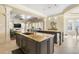 Open kitchen with large island featuring granite countertop, dark cabinets, tiled floors and open floor plan at 4202 Links Ct, North Charleston, SC 29420