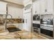 A gourmet kitchen with granite countertops, stainless steel appliances, and custom white cabinetry at 4202 Links Ct, North Charleston, SC 29420