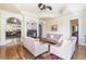 Cozy living room featuring hardwood floors, plush sofas, a fireplace, and ornate architectural details at 4202 Links Ct, North Charleston, SC 29420