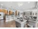 Spacious living area with multiple chairs, a bar, and access to a patio and kitchen at 4202 Links Ct, North Charleston, SC 29420