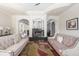 Comfortable living room with hardwood floors, elegant sofas, fireplace, and detailed architectural features at 4202 Links Ct, North Charleston, SC 29420