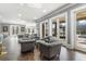 Large living room has multiple chairs and access to a patio with a swimming pool at 4202 Links Ct, North Charleston, SC 29420