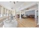 Expansive living area with hardwood floors, white sofas, large windows, and open floor plan to the kitchen at 4202 Links Ct, North Charleston, SC 29420