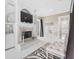 Main bedroom featuring a fireplace, mounted TV, zebra-patterned rug, and a sitting area at 4202 Links Ct, North Charleston, SC 29420