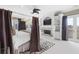 An elegant bedroom features a fireplace, canopy bed, and access to a private balcony with beautiful outdoor views at 4202 Links Ct, North Charleston, SC 29420