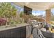 Outdoor kitchen featuring a stainless steel grill, sink, countertop prep area, and patio seating with stylish design at 4202 Links Ct, North Charleston, SC 29420