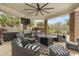 Covered outdoor kitchen and patio area featuring a built-in grill, bar seating, and comfortable lounge furniture at 4202 Links Ct, North Charleston, SC 29420