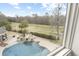 A view from above shows a private backyard oasis with a pristine pool, rock waterfall, and lush greenery at 4202 Links Ct, North Charleston, SC 29420