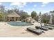 A backyard pool with a stone waterfall feature, covered gazebo, and striped lounge chairs offers resort-style living at 4202 Links Ct, North Charleston, SC 29420