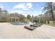 A backyard oasis features a beautiful pool, stone waterfall, a covered cabana, and lounge chairs at 4202 Links Ct, North Charleston, SC 29420