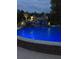Beautiful backyard pool with waterfall feature and illuminated lights at 4202 Links Ct, North Charleston, SC 29420
