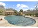 Backyard oasis with a sparkling pool, rock waterfall feature, and an outdoor pavilion offering a perfect setting for relaxation at 4202 Links Ct, North Charleston, SC 29420