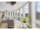 Bright sunroom with floor-to-ceiling windows, hardwood floors, ceiling fans, and wicker furniture at 4202 Links Ct, North Charleston, SC 29420