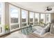 A relaxing sunroom features many large windows, wicker furniture, and a ceiling fan at 4202 Links Ct, North Charleston, SC 29420