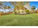 Green grass in a spacious backyard with wooden fence surrounding the perimeter with a view of the back of the house at 422 Sanders Farm Ln, Charleston, SC 29492