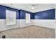 Bedroom featuring two windows, carpeted floors, and white wainscotting at 422 Sanders Farm Ln, Charleston, SC 29492