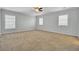 Spacious bedroom with neutral carpet, fresh paint, and plenty of natural light from three windows at 422 Sanders Farm Ln, Charleston, SC 29492