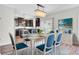 Charming dining area features a chandelier, white table with blue upholstered chairs at 422 Sanders Farm Ln, Charleston, SC 29492