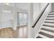 Bright foyer with hardwood floors, white door, stairs, and view to living room at 422 Sanders Farm Ln, Charleston, SC 29492