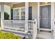 Inviting front porch with white railing and a charming door with an anchor accent at 422 Sanders Farm Ln, Charleston, SC 29492
