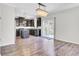 Open kitchen with stainless appliances, dark cabinets, island, and hardwood floors at 422 Sanders Farm Ln, Charleston, SC 29492