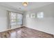 A well-lit living room with hardwood floors, wainscoting, and three large windows at 422 Sanders Farm Ln, Charleston, SC 29492