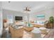 Bright living room features wicker furniture set, ceiling fan, and light hardwood floors at 422 Sanders Farm Ln, Charleston, SC 29492